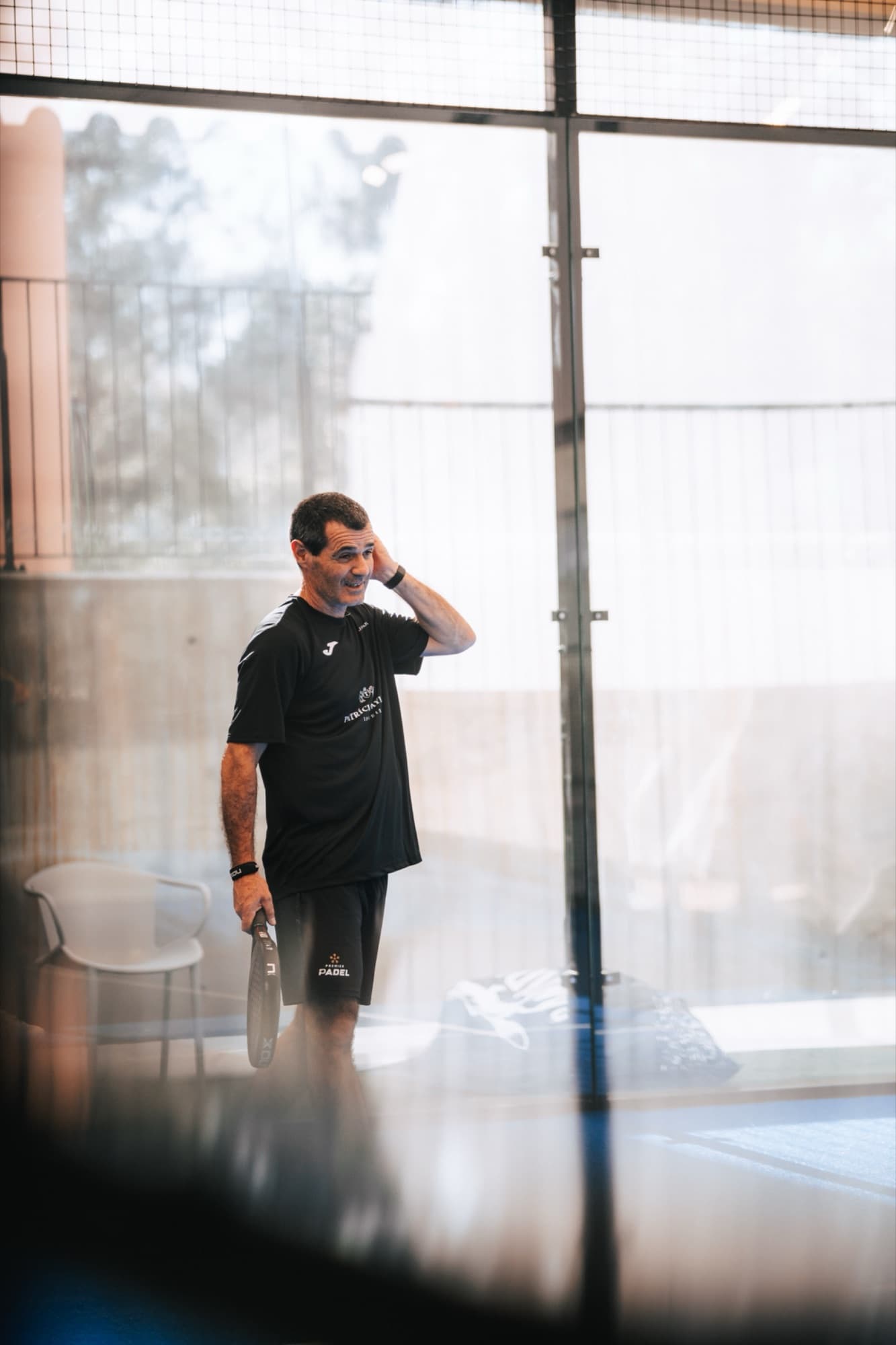 Coach at Peru Padel holding a paddle